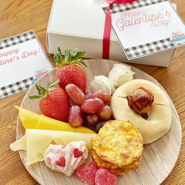 Koch's General Store deli platter with fruit, cheese, bagel, quiche, and heart-shaped cookies.